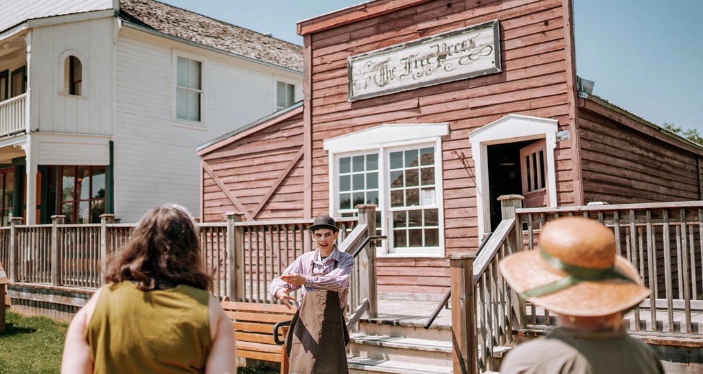 Fanshawe Pioneer Village merchant asking people to come into his store